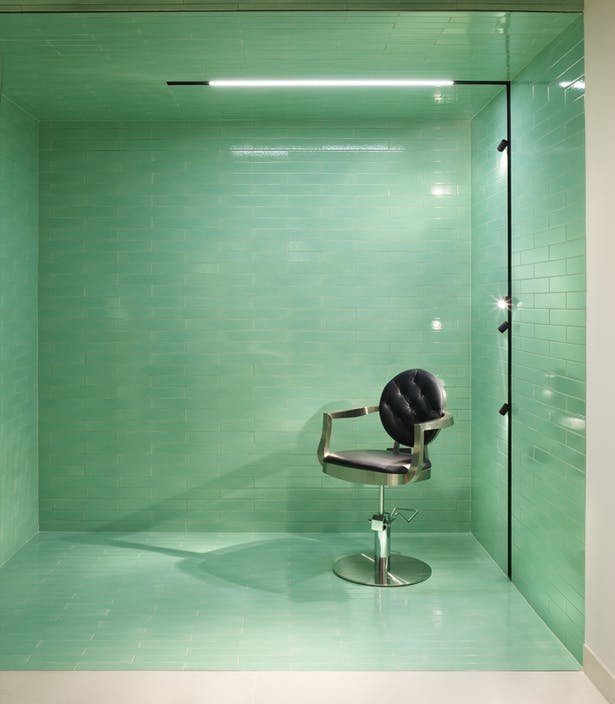 "sleek lighting and green tiling"
