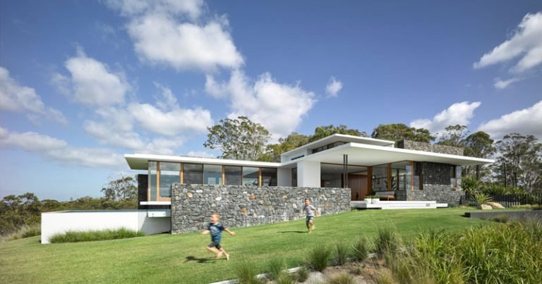 This Mid-Century Inspired House Has A Hidden Door In A Stone Wall