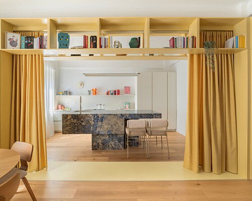 folded yellow volume reorganizes genova apartment’s interiors like a game of tetris