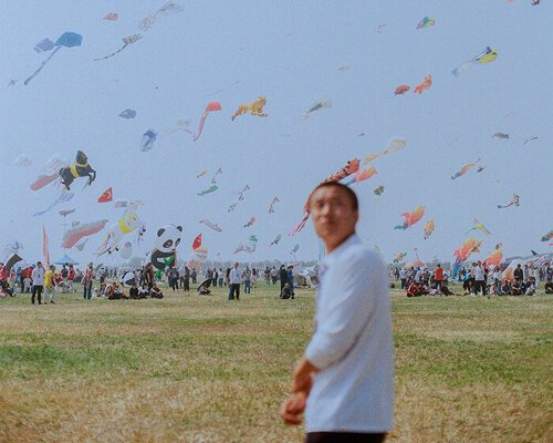 beneath a kite-filled sky in china, janice chan photographs tropical fish and noodle packets