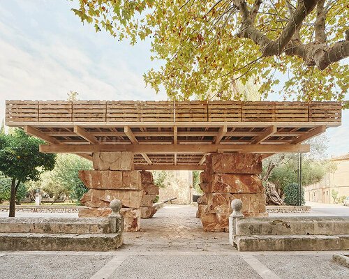 aulets stacks natural stone beneath a recycled pallet roof in mallorca