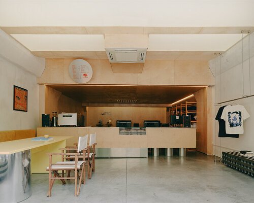 plywood and reflective steel build retro-futurist print shop in tbilisi’s former factory