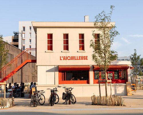 former railway signal box reopens as l’aiguilleuse red-orange kiosk-bar in nantes