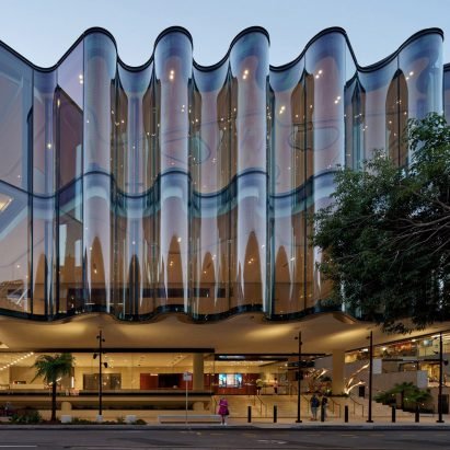 Seven buildings draped with fabric-like glass facades