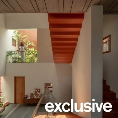 SpaceDNA arranges split levels of Indian home around rust-orange staircase