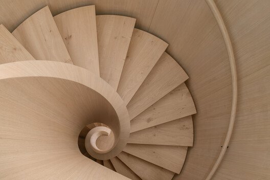 
        Transforming a Concrete Shell into a Wooden Interior Shaped by the Sea
      